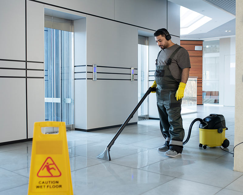 Warehouse cleaning Dubai — Spring Blue crew cleaning a Dubai industrial warehouse floor